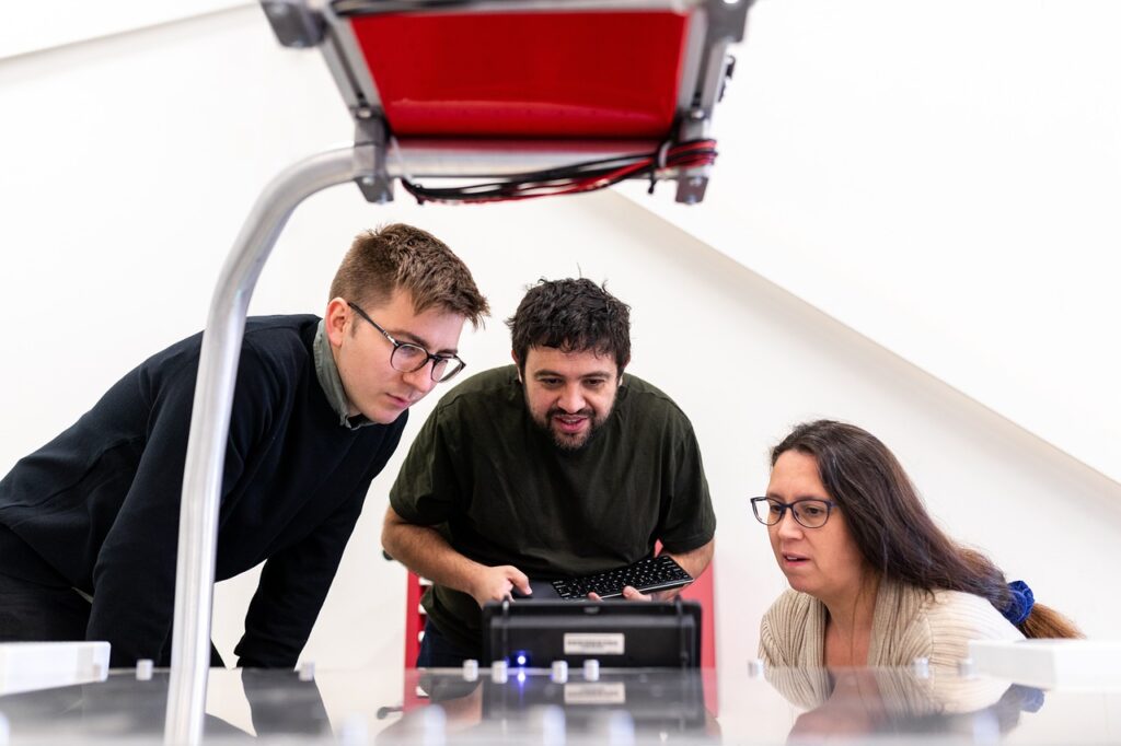 3 Person trying to do an experiment